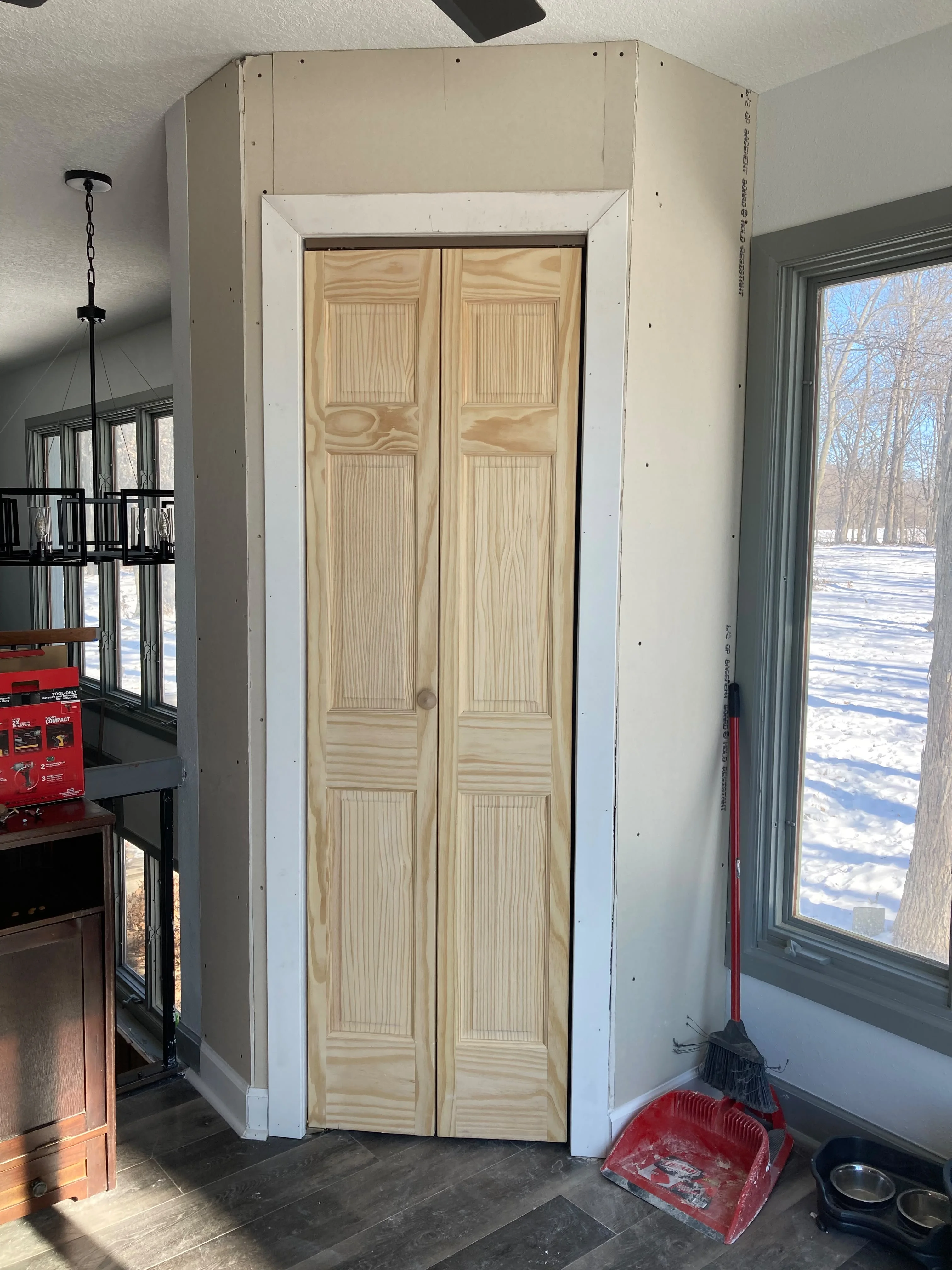 New pine bifold closet doors installed, bright Des Moines home