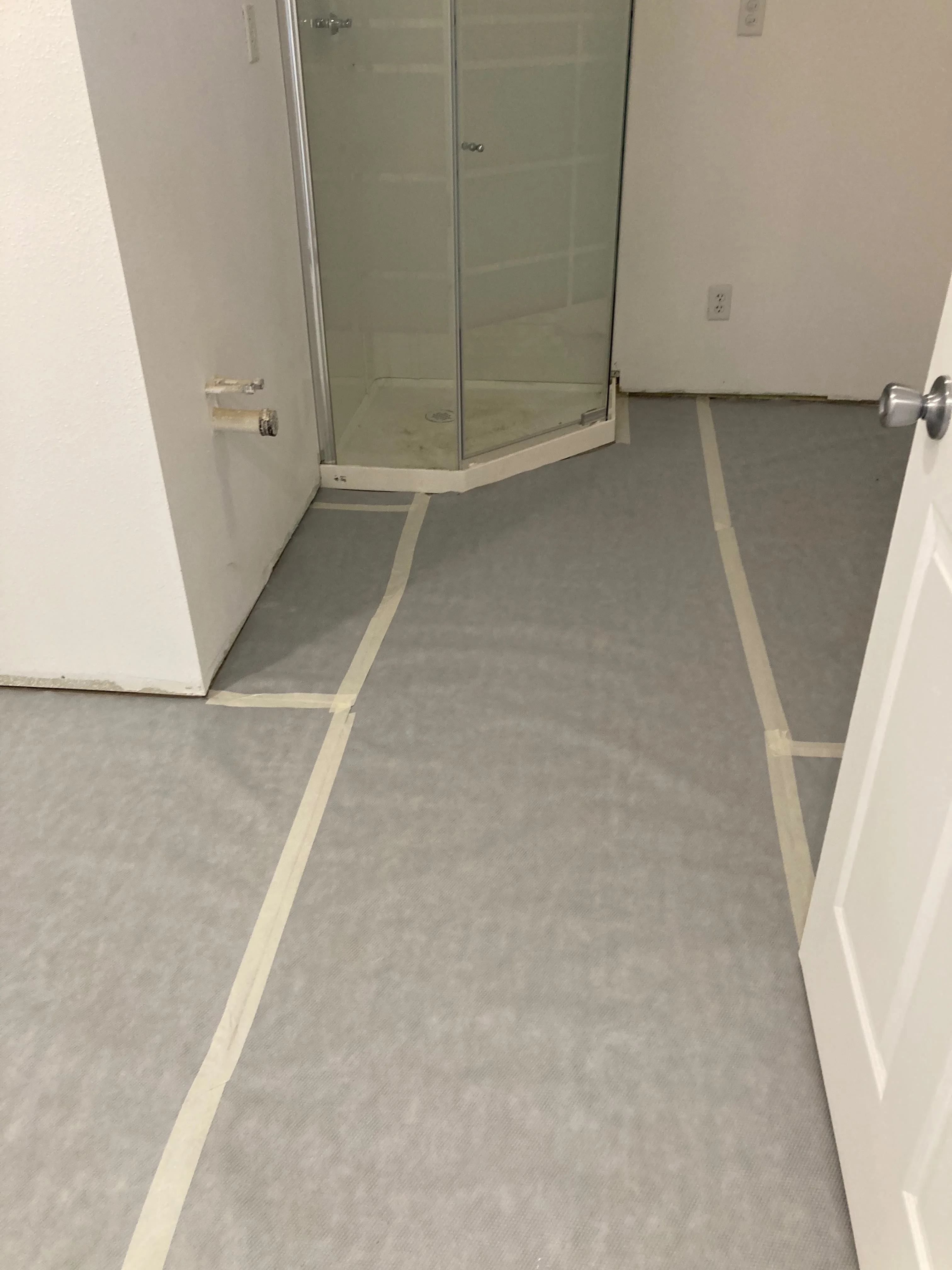 New glass shower enclosure and flooring installation