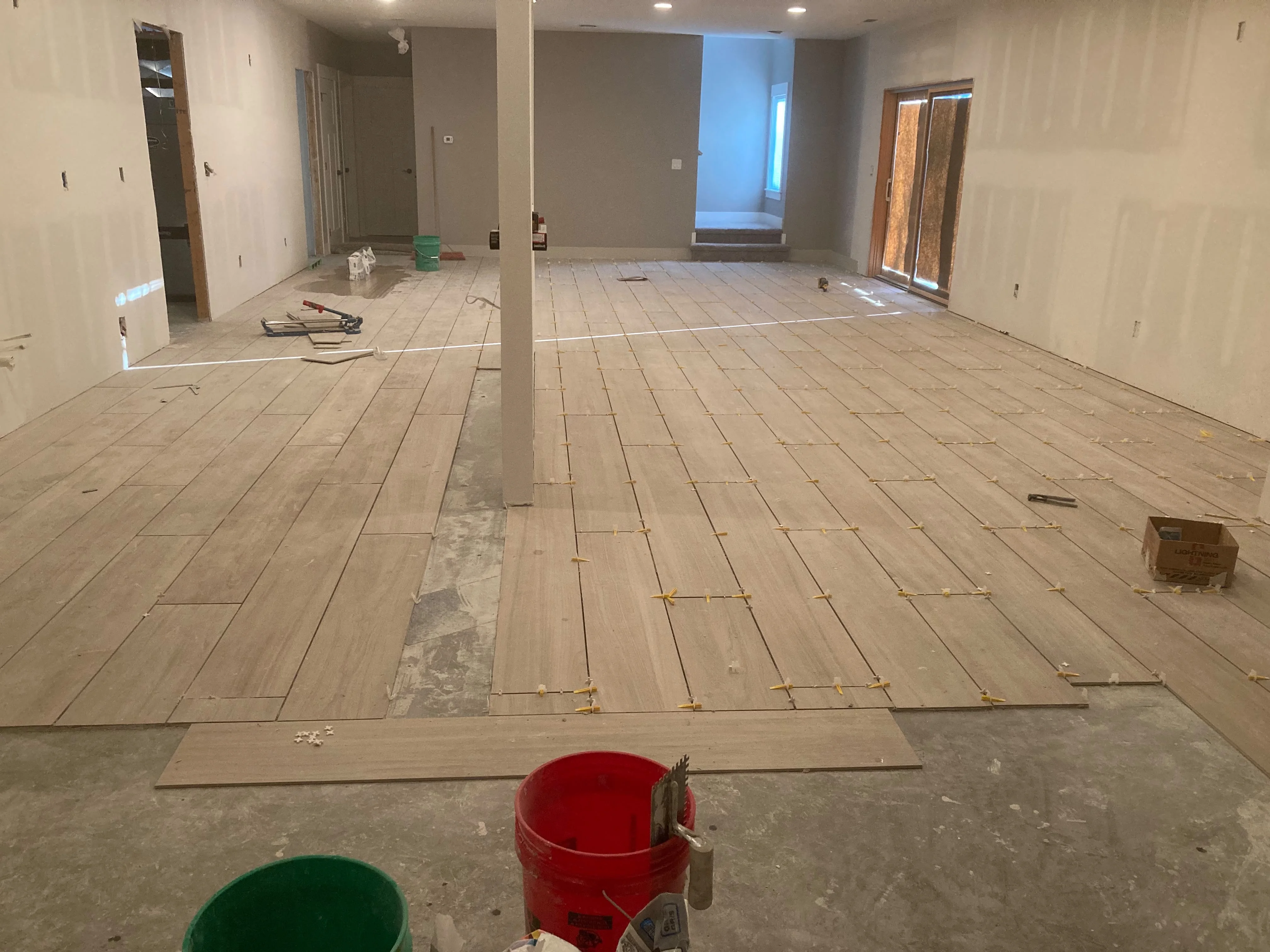 New plank tile flooring installation in a Des Moines living area