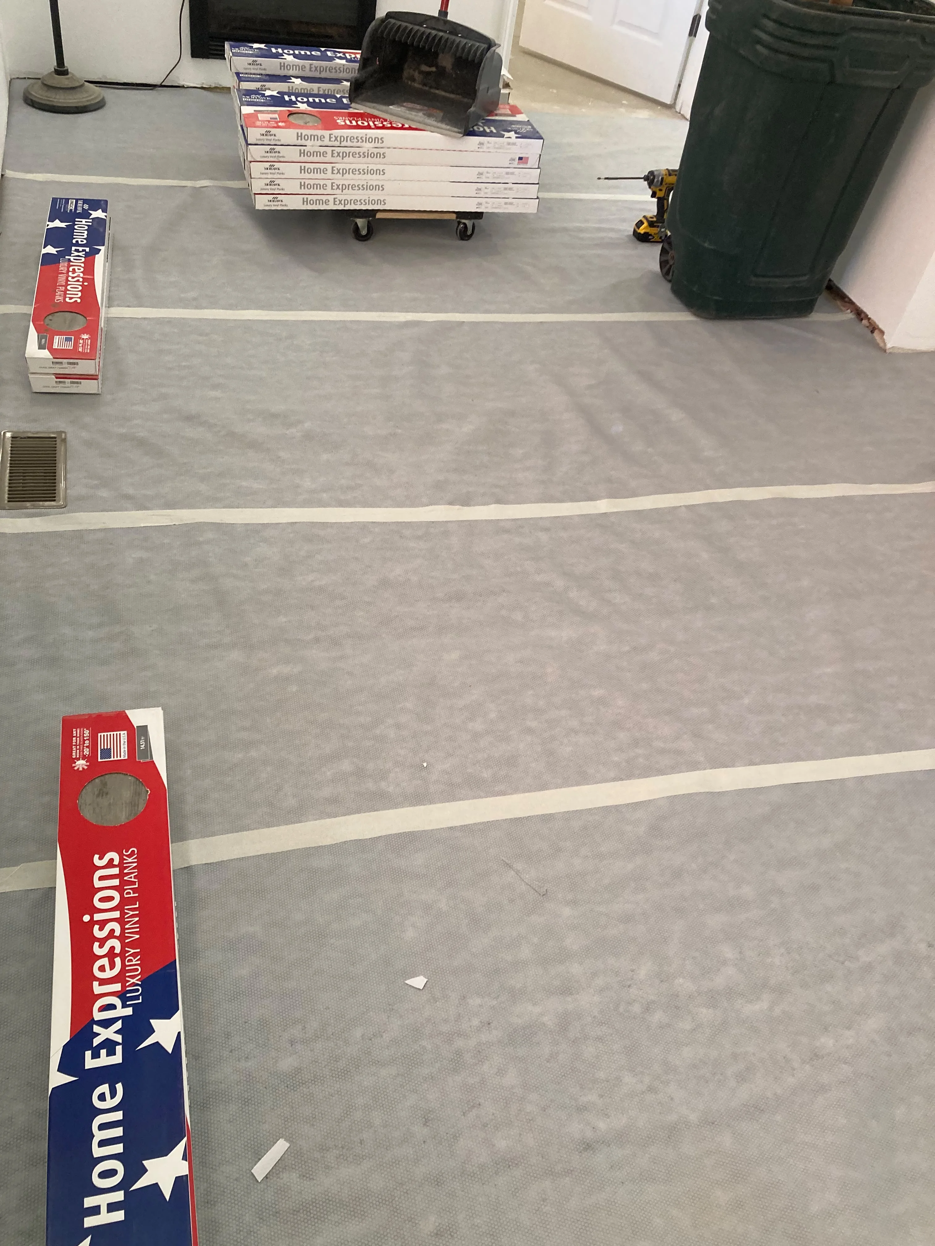 Luxury vinyl plank flooring staged for a living room installation