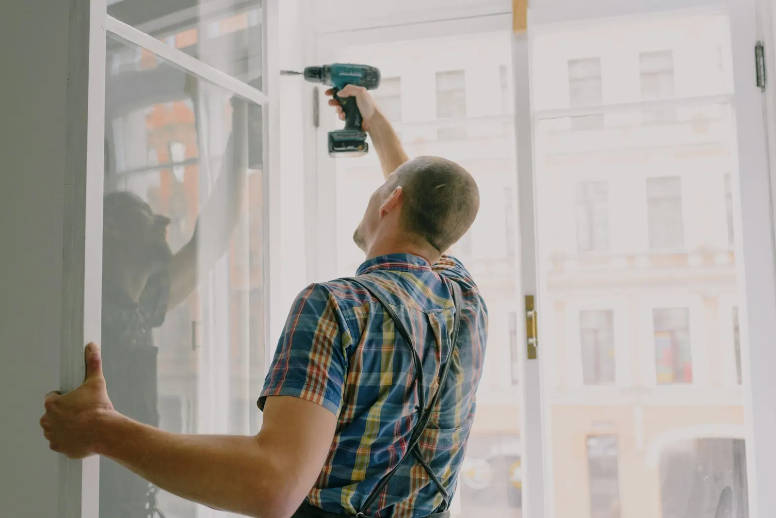 Window repair technician working on a Des Moines home